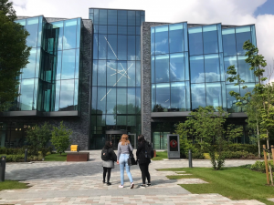 three women walking towards a building