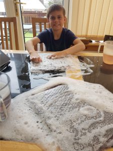 Photo of a child making felt with bubble wrap and soapy water